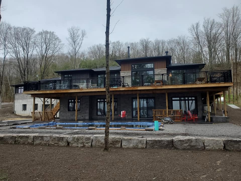 Modern cottage project with installed windows and doors during exterior construction