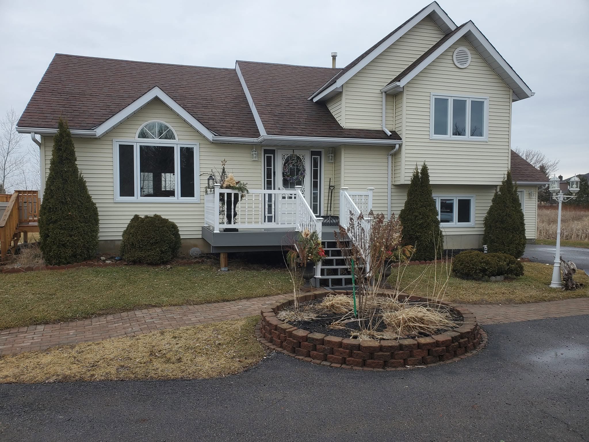 Completed home with white-framed replacement windows and a large front picture window