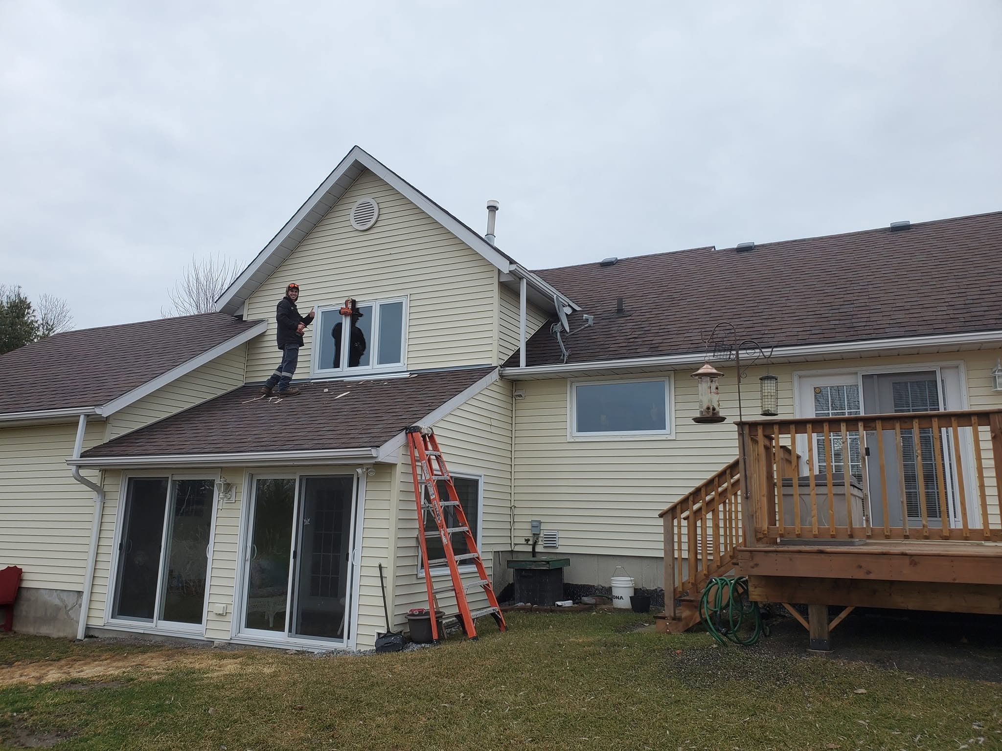 Cottage exterior with new sliding glass patio doors and a deck
