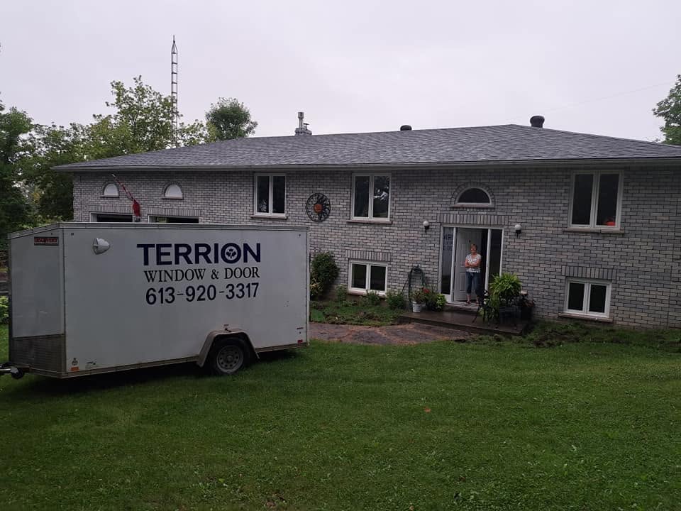 Terrion Window and Door trailer parked outside a residential property
