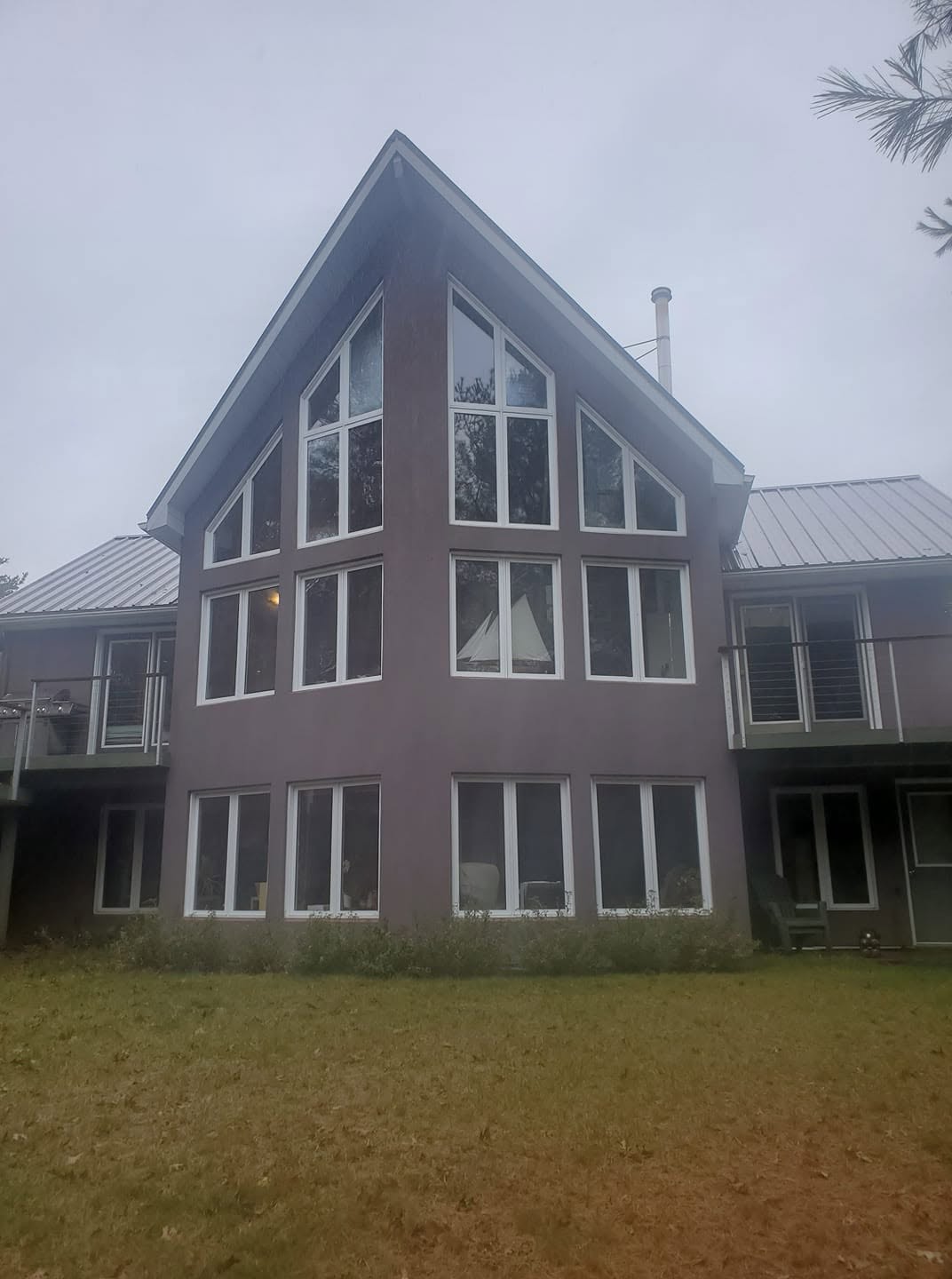 Completed multi-level cottage with white-framed replacement windows